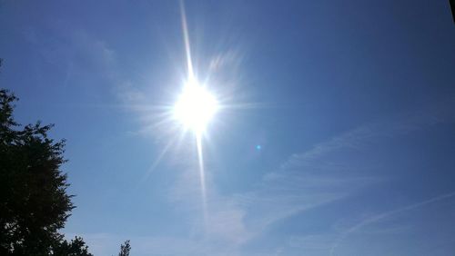 Low angle view of vapor trail in blue sky