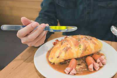 Close-up of man holding food in plate