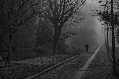 View of woman walking on road