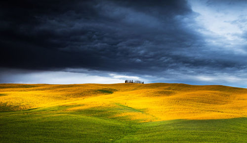 Scenic view of landscape against cloudy sky