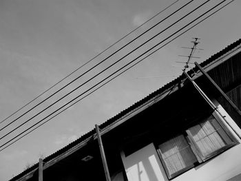 Low angle view of cables against sky