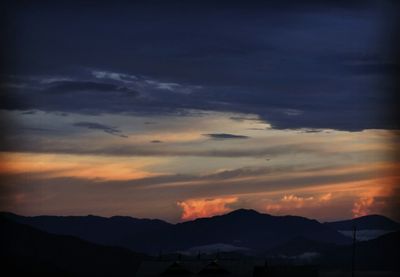 Scenic view of silhouette mountains against sky during sunset