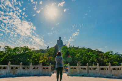 Rear view of man standing against sky