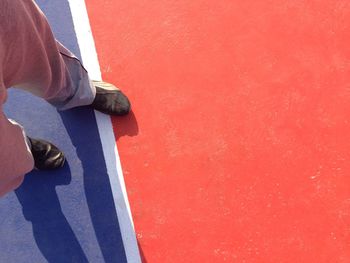 Low section of man standing on basketball court