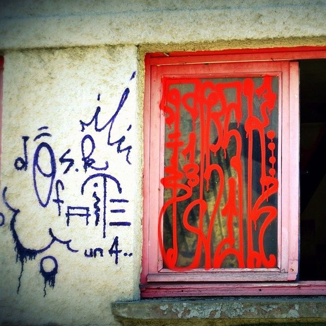 text, architecture, graffiti, built structure, wall - building feature, creativity, western script, art, art and craft, communication, red, building exterior, wall, door, street art, brick wall, close-up, capital letter, closed, window