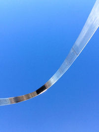 Low angle view of trees against clear blue sky