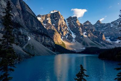 Scenic view of lake and snowcapped mountains against sky