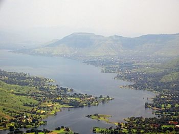 Scenic view of river and mountains against sky