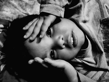 Close-up portrait of boy on bed