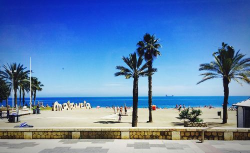 Scenic view of beach against blue sky