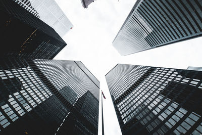 Directly below shot of modern office buildings against sky