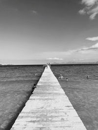 Pier over sea against sky