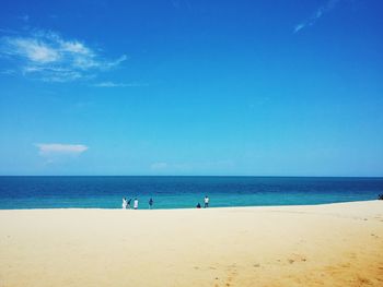 Scenic view of beach against blue sky