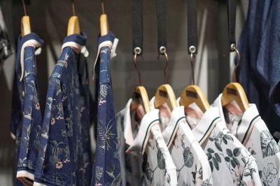 Close-up of clothes hanging on rack for sale in store