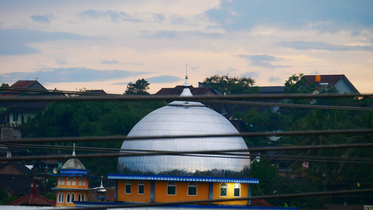 BUILDING AGAINST SKY AT DUSK