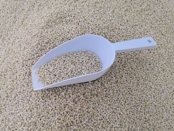 High angle view of coffee cup on sand