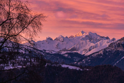 Scenic view of snowcapped mountains against sky during sunset