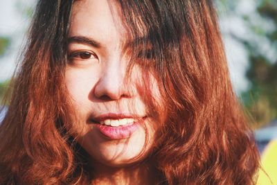 Close-up portrait of a smiling young woman
