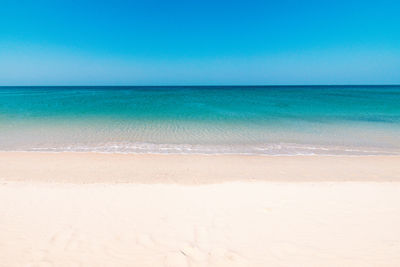 Scenic view of sea against clear blue sky