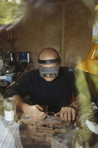 Portrait of a man sitting on table