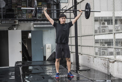 Man training at rooftop gym in bangkok