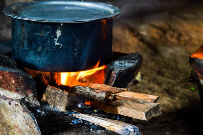 Close-up of container on camping stove at night