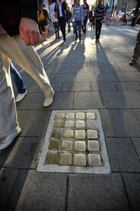 Low section of people walking on footpath