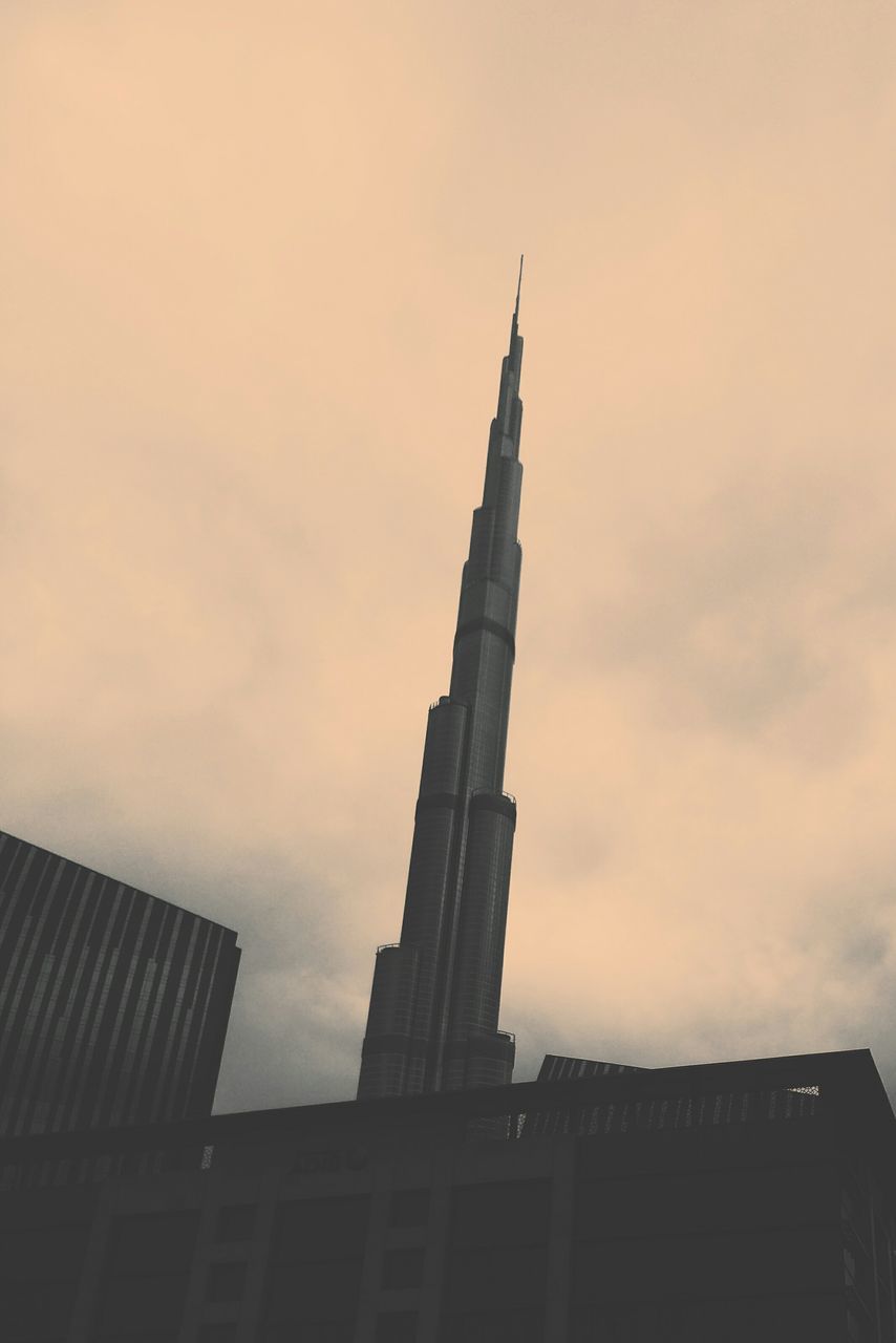 Low angle view of burj khalifa against sky during sunset