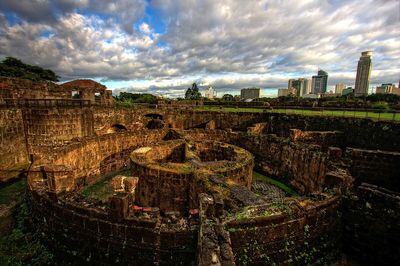 Buildings against cloudy sky