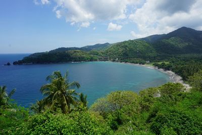 Scenic view of sea and mountains against sky