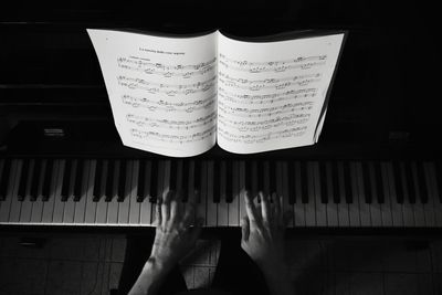 Low angle view of hand playing piano