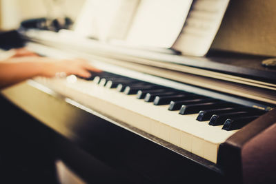 Close-up of hands playing piano