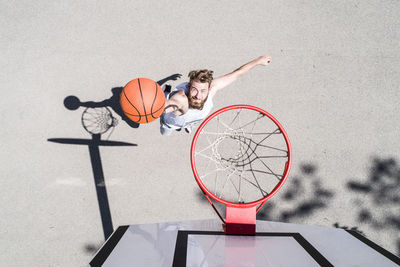 Man playing basketball on outdoor court