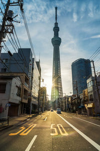 View of city street and buildings against sky