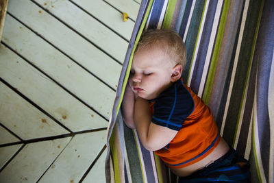 Close up of chubby cheeked toddler sleeping in hammock in caribbean