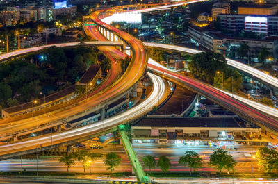 High angle view of illuminated bridges in city at night