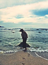 Full length of woman on beach against sky