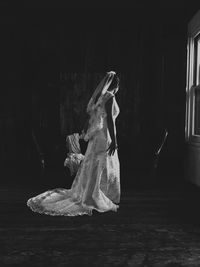 Side view of bride standing in room at home