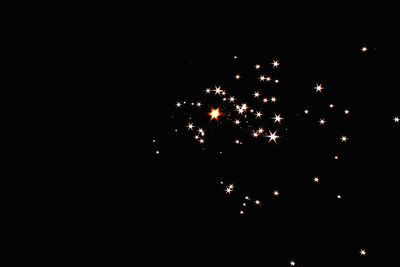Firework display over black background