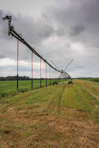 Windmills on field against sky