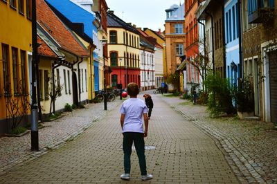 Rear view of man walking on street