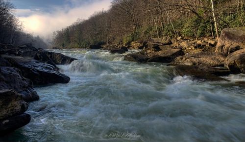 Scenic view of river flowing through rocks