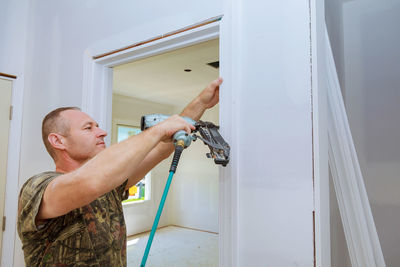 Man drilling door at home