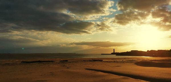 Scenic view of beach against sky during sunset