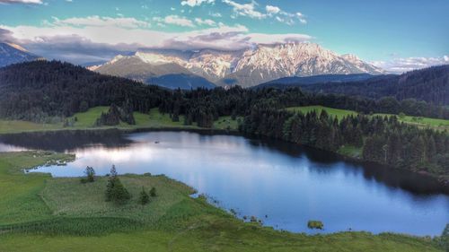 Scenic view of lake and mountains against sky