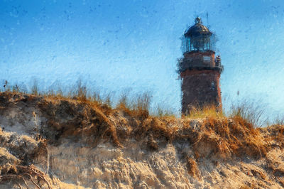 Lighthouse against sky during winter