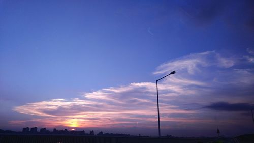 View of street light against cloudy sky