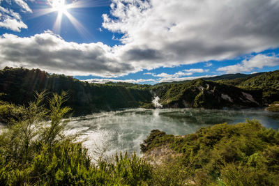 Scenic view of waterfall against sky