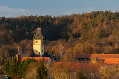 High angle view of trees and buildings against sky