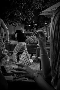 Rear view of people sitting in park